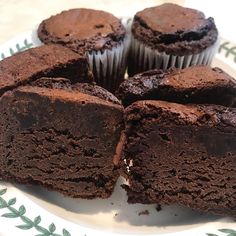 chocolate cupcakes on a plate with one cut in half