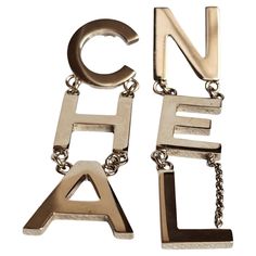 Iconic chanel lettering drop earrings. Beautiful statement piece. Easy to pair with anything. Comes with its box and ribbon. Minor scuffing on the hardware throughout. Light gold. Letter Earrings, Chanel Logo, Jewelry Earrings Dangle, Chanel, Dangle Earrings, Jewelry Earrings, Drop Earrings, Gold