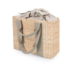 a wicker bag with a ribbon tied around the top and bottom, on a white background