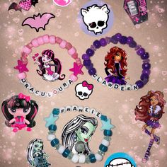 there are many different bracelets with pictures on them in the shape of monster dolls