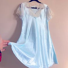 Vintage Intimate Essentials Baby Blue Satin Baby Doll Dress With Delicate Lace Detailing. Nwt In New With Tags Condition. Super Lightweight Satin Material. Reference All Images And Measurements Before Purchase. Feel Free To Ask For Additional If Needed. No Returns. Approx. Measurements Taken From Seam To Seam While The Garment Is Lying Flat. Chest: 19” Waist: 18” Length: 35.5” Smoke Free Home. I’m Open To All Reasonable Offers. Please Use The Send Offer Button Or Click “Buy Now!” No Returns. Bun Blue Short Sleeve Nightgown For Bedtime, Blue V-neck Nightgown With Lace Trim, Blue V-neck Sleepwear With Lace Trim, Light Blue Lace Trim Dress For Loungewear, Light Blue Short Sleeve Sleep Dress, Blue Nightgown For Wedding Night In Summer, Blue Lace Trim Nightgown For Pajama Party, Blue Lace Nightgown For Loungewear, Blue Lace Trim Nightgown For Sleep