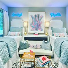 two beds in a room with blue and pink decor