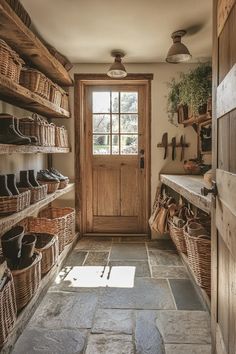 Rustic English country mudroom with reclaimed wood shelves wicker baskets and stone flooring Mudroom Door To Garage, Mountain House Mudroom, English Country Life, Small Boot Room Ideas, Country Mudroom Ideas, Farm House Mud Room, Moody Mudroom, Country Mudroom, Boot Room Ideas