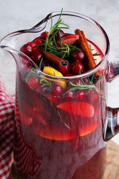 a pitcher filled with cranberries and spices