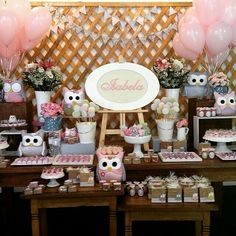 an owl themed birthday party with pink and white balloons, cupcakes, candy bar