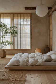 a bed sitting on top of a wooden floor next to a window