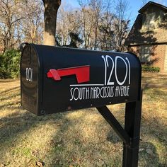 a black mailbox with the words south marquess avenue painted on it in front of a house