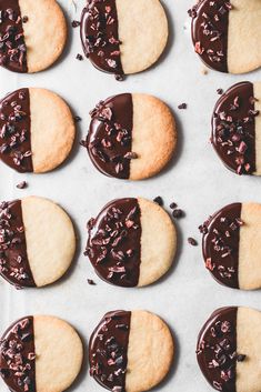 chocolate covered cookies are arranged on a baking sheet