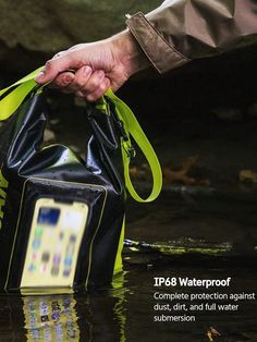 a person holding a waterproof bag in the middle of a stream with text on it