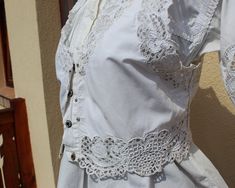 Antique Hungarian white vest with blouse hand embroidered S size If you are buying several pieces I can combine postage at the time of mailing. If you have any question please don't hesitate to contact me, My etsy shop: https://www.etsy.com/shop/TreasuryCoffer Floral Peasant Blouse, Hungarian Embroidery, White Vest, Lace Vest, Vest White, Peasant Blouse, Blouse Vintage, Embroidered Blouse, Vest Top