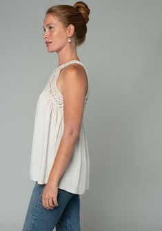 A sheer crochet-knit yoke adds a bohemian touch to this flowy tank top. Featuring a sexy racerback with a peek-a-boo keyhole detail. Perfect for festival season, we love to style this easy tank top with denim cut-offs and a simple sandal. Open knit crochet Textured floral jacquard Relaxed, flowy fit Sleeveless Crochet yoke Round neckline Racerback Back keyhole Hook & eye closure Bohemian crochet tank top Model is 5'9, wearing a size S.Style: I-13907W-RTW Womens Tank Tops Summer, Bohemian Crochet, Crochet Yoke, Simple Sandals, Crochet Tank Top, Crochet Tank, Floral Jacquard, Denim Cutoffs, Summer Tank