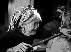 black and white photograph of an old woman holding a baseball bat with another woman behind her