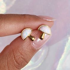 "Opal Mushroom Stud Earrings - We have so mush love for these adorable lab-grown opal & gold mushroom earrings! Delicate size is perfect for primary or secondary + ear piercings! Wildflower + Co. ♥ Measures approx. 3/8\" ♥ Materials: dipped in 12 K gold plating & lab grown synthetic opal Posts are titanium - good for sensitive ears! ♥ Packaged in our cute gift box ♥ Designed by & exclusive to Wildflower + Co. ♥ Imported ♥ Product safety - intended for use by adults only; CA residents - see shop Gold Mushroom Design Drop Earrings, White Mushroom Design Drop Earrings, Gold Earrings With Mushroom Design For Gift, Gift Gold Earrings With Mushroom Design, Ear Curation, Cottagecore Earrings, Mushroom Jewelry, Mushroom Earrings, Earrings Opal