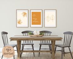 a dining room table with four chairs and two pictures hanging on the wall above it