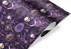 a purple and black wrapping paper with skulls, flowers and other things on the surface