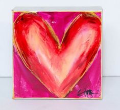 a painting of a red heart on a pink background