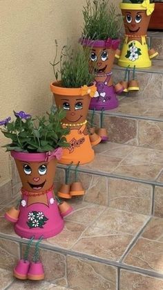 several pots with plants in them sitting on the steps