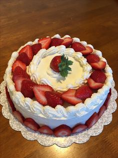 there is a cake with strawberries on the top and frosting in the middle