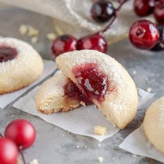 cranberry cookies with powdered sugar and fresh cherries on the side, ready to be eaten