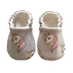 "Baby Pram Shoes handmade little soft soled crib shoes in a gorgeous print of pastel coloured Unicorns  with Rainbow mane on soft lilac cotton jersey knit fabric, available with 4 different sole types. Perfect New Baby Gift! Pram Shoes are made from 100% cotton knit with a super soft organic cotton bamboo knit lining, fully reversible with no raw edges to irritate babies feet and elasticated heel - ensuring comfort for your little one. Choose from the following sole options; Soft Jersey Knit (of Girls Gift Idea, Unicorn Shoes, Newborn Shoes, Baby Moccasins, Kids Slippers, Shoes Soft, Baby Slippers, Shoe Gifts, Crib Shoes