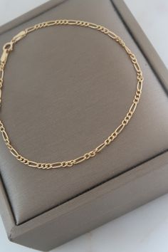 18k Solid Gold Figaro Chain Bracelet. Length: 6 5/8" Width: 1mm Weight: 0.74 grams  Marked: 750 (18k solid gold) Back to the shop: https://www.etsy.com/shop/SusVintage?ref=hdr_shop_menu If you have any questions feel free to contact me. Thank you!! Dainty Gold Plated Bracelet With Figaro Chain, Dainty Gold-plated Bracelet With Figaro Chain, Dainty Gold Bracelet With Figaro Chain, Dainty Gold Figaro Chain Bracelet, Fine Jewelry Gold Link Bracelet As Gift, Dainty Bracelet With Figaro Chain Link, Fine Jewelry Hallmarked Link Jewelry, Yellow Gold-plated Sterling Silver Bracelet As Gift, Dainty 14k Gold Bracelet With Figaro Chain