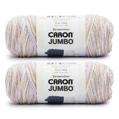 two skeins of yarn with the words dragon jumbo written in black and white