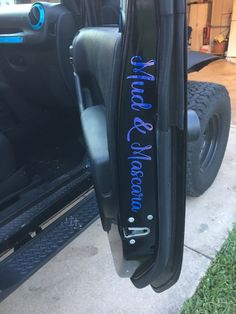 the side view mirror of a vehicle with blue lettering on it's side door