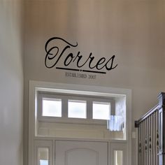 there is a sign that says torress on the wall above the front door