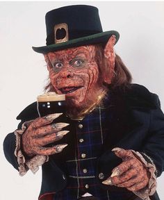 a man dressed in costume holding a beer