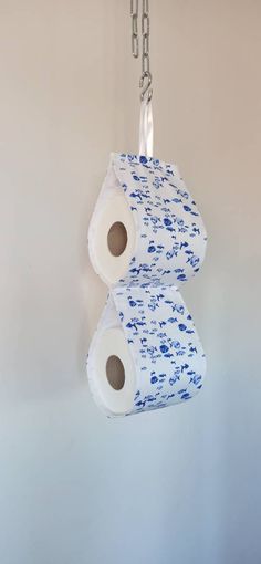 two rolls of toilet paper hanging from a chain