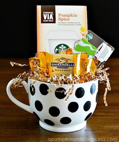 a polka dot coffee cup filled with various items