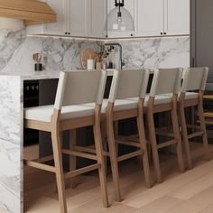 a kitchen with marble counter tops and wooden chairs