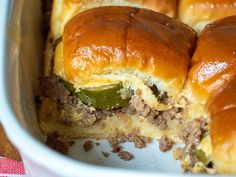 the meat and cheese sliders are ready to be eaten in the casserole dish