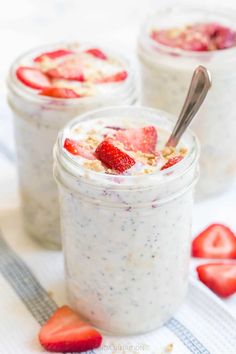 three mason jars filled with overnight oatmeal and topped with fresh strawberries