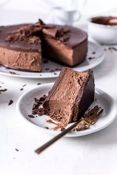 two plates with slices of chocolate cake on them