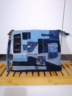 a purse made out of old jeans is sitting on a shelf