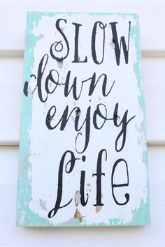 a sign that says slow down enjoy life