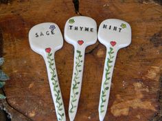 three ceramic spoons that say sage, thyme, mint and rose on them