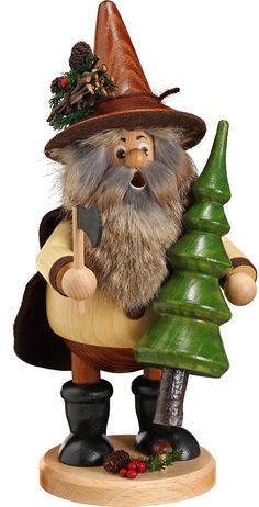 a gnome figurine holding a christmas tree