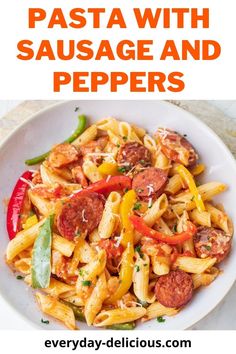 pasta with sausage and peppers in a white bowl