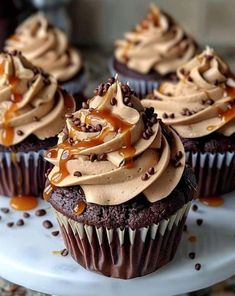 chocolate cupcakes with caramel frosting on a white plate