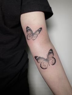 two butterflies tattoo on the arm