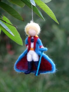 a needle felt ornament hanging from a tree