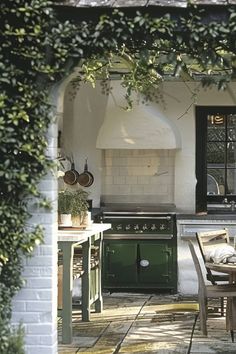 an outdoor kitchen and dining area is shown