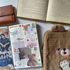 an open book with pictures on it next to a teddy bear and wallet, along with other items