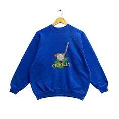 "Code : w/25 Vintage 90s Golf Sweatshirt Golf Crewneck Golf Sports Sweater Pullover Golf Club Graphics Golf Art Embroidery Baggy Blue Size Large Size on Tag :  L Details Measurement  Arm Pit to Arm Pit : 23.5\"inches Back Collar to Hem : 25\"inches Condition :  Great Vintage Condition(Used Clothing).No Holes And No Stain.Please refer pictures detail.‼️" Blue Sporty Sweater With Embroidered Logo, Sporty Blue Sweatshirt With Embroidered Graphics, Blue Crew Neck Sweater With Embroidered Graphics, Blue Sports Sweatshirt With Embroidered Logo, Blue Crew Sweater With Embroidered Graphics, Blue Sweatshirt With Embroidered Logo For Sports, Blue Sporty Sweatshirt With Embroidered Graphics, Blue Crew Neck Top For Golf, Blue Retro Sweatshirt For College