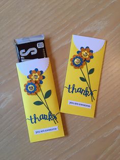 two yellow tags with flowers and the words thank written on them