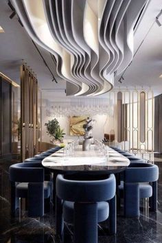 an elegant dining room with blue chairs and marble counter tops