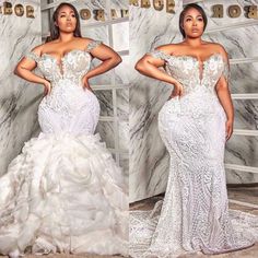 a woman in a white gown standing next to a marble wall and posing for the camera