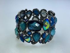 Vintage 6.5" Bracelet Stretchy Oxidized With AB Blue And Purple Rhinestones Used Blue Crystal Bracelet For Party, Adjustable Blue Bracelets With Sparkling Stones, Blue Crystal Bracelet With Rhinestones For Party, Blue Crystal Bracelet With Sparkling Stones, Blue Rhinestone Crystal Bracelet For Party, Blue Crystal Bracelet With Rhinestones, Party Blue Crystal Bracelets, Adjustable Turquoise Crystal Bracelet For Parties, Adjustable Blue Crystal Bracelet With Stones